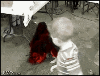 a baby and a dog are playing in a room with the website 4gifs.com in the corner