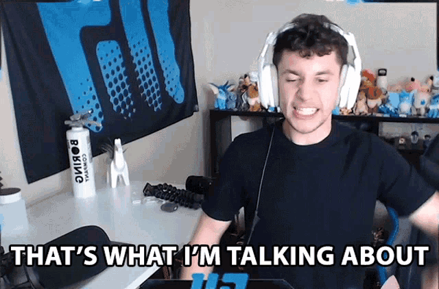 a man wearing headphones with the words that 's what i 'm talking about behind him