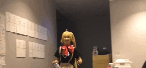 a woman in a costume is holding a bottle of water in a hallway