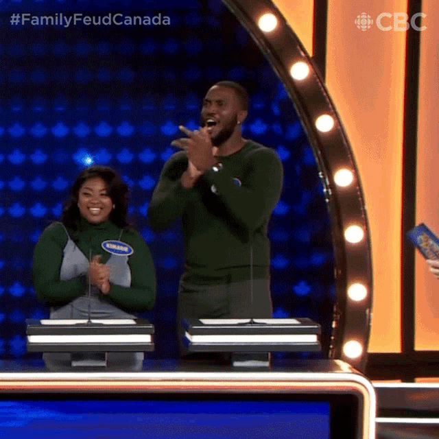 a man and a woman on a family feud game show