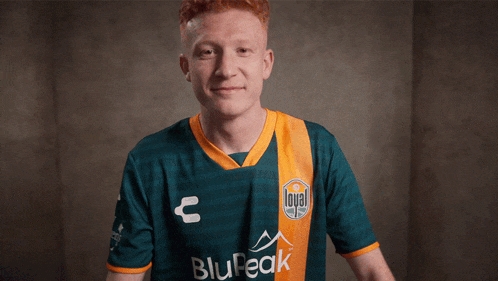 a man wearing a green and orange shirt with the word loyal on the front