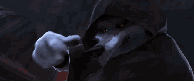a wolf with red eyes is wearing a black hood