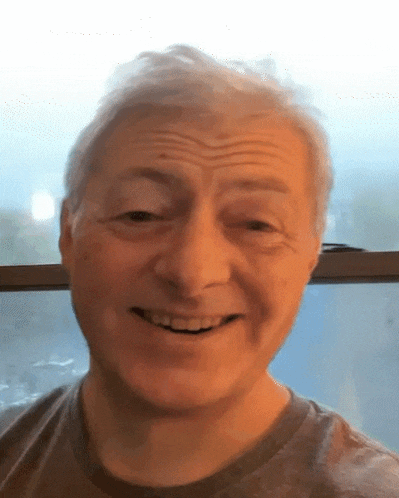 a close up of a man 's face with a smile
