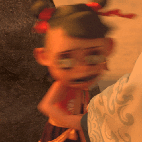 a blurry picture of a cartoon character with a swirl pattern on her shirt