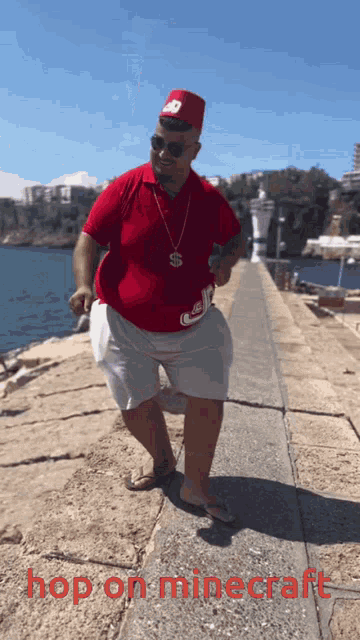a man in a red shirt and white shorts is dancing in front of a body of water with the words hop on minecraft written below him