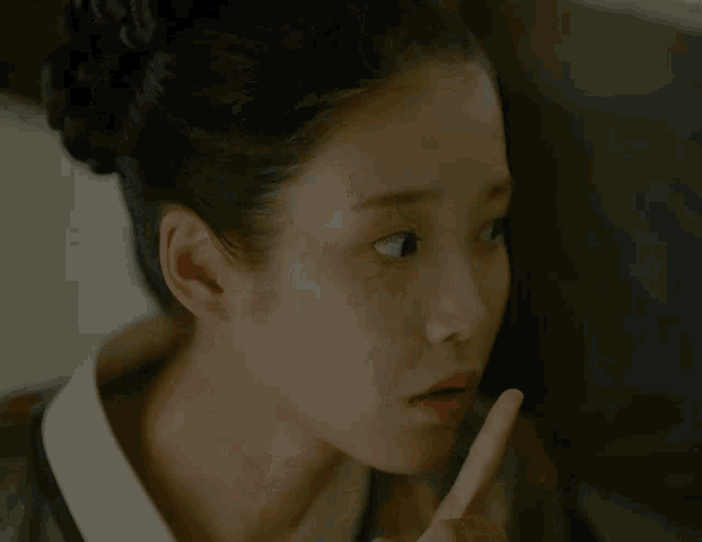 a close up of a woman 's face with a surprised look