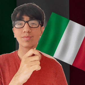 a young man wearing glasses holds a green white and red flag