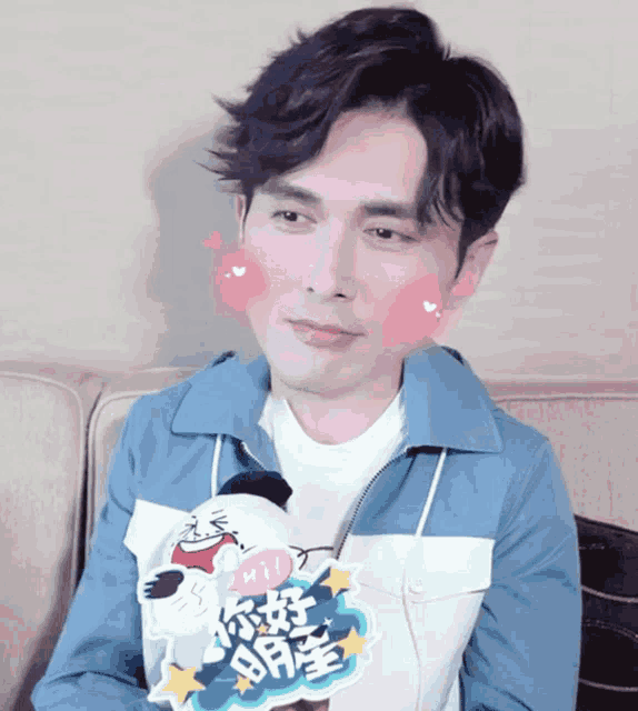 a man sitting on a couch with a sticker that says " hi " on it