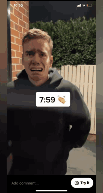 a phone screen shows a man crying with the time of 7:59 on it