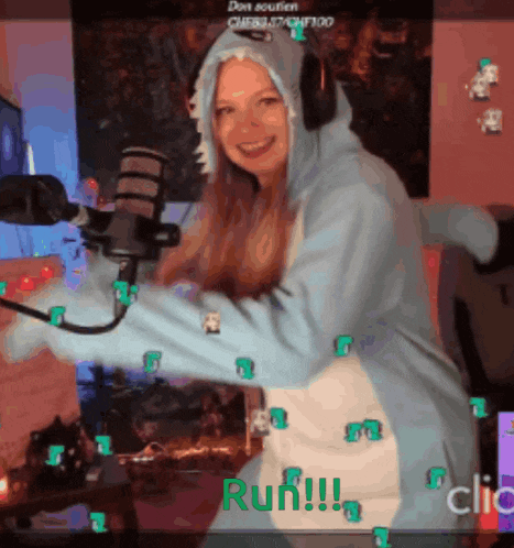 a woman wearing a shark costume is dancing in front of a microphone