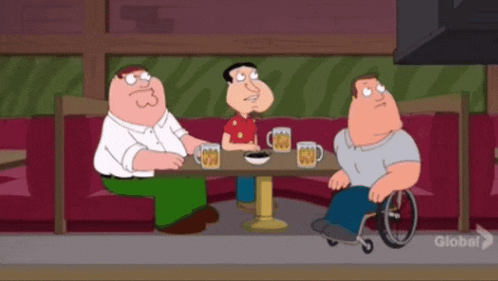 three cartoon characters are sitting around a table with a man in a wheelchair