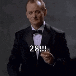 a man in a tuxedo is holding a glass of whiskey and saying `` happy birthday to you ! ''