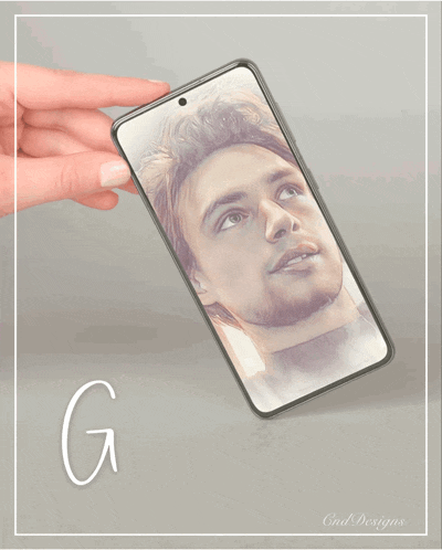 a hand is holding a cell phone with a picture of a man on it and the words good morning