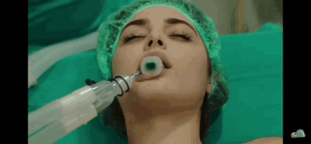 a woman with an oxygen mask in her mouth is laying on a bed