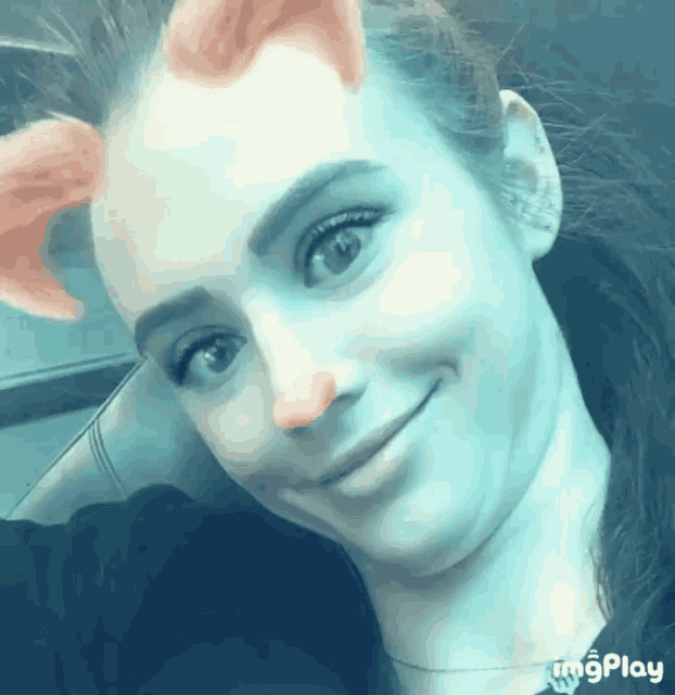 a close up of a woman 's face with a cat ear filter on her face
