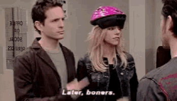 a woman wearing a pink helmet is talking to a man .
