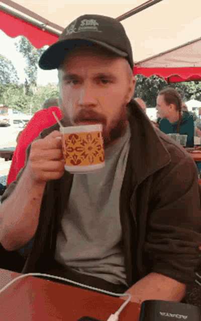 a man wearing a hat that says ' sun ' on it