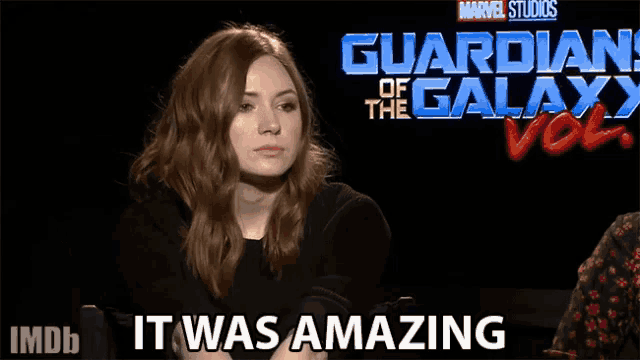 a woman sitting in front of a guardian of the galaxy vol 2 poster