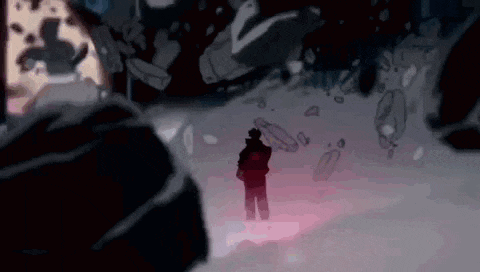 a man is standing in a dark room with a red light coming out of the ground .