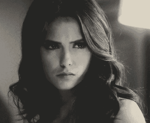 a close up of a woman 's face with a serious look on her face
