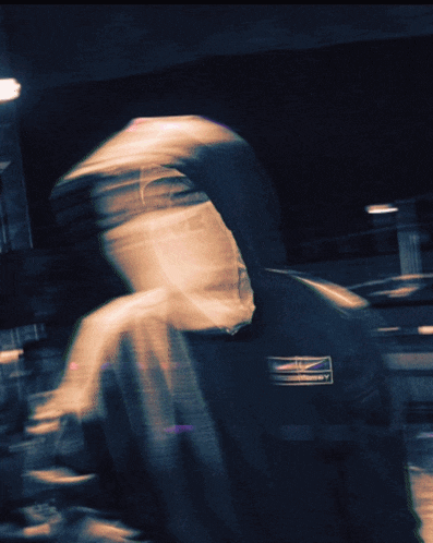 a blurry image of a person with a hoodie that says ' abercrombie & fitch ' on it