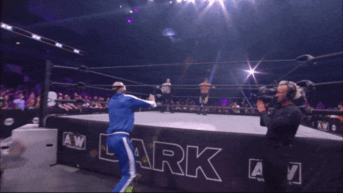 a wrestler is kneeling in front of a sign that says darkz