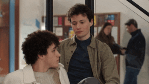 a couple of young men standing next to each other