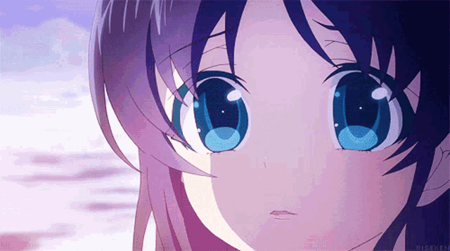 a close up of a girl 's face with blue eyes and a purple hair