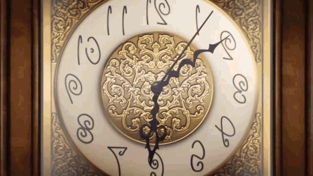 a gold and white clock with the hands on the numbers 4 and 9