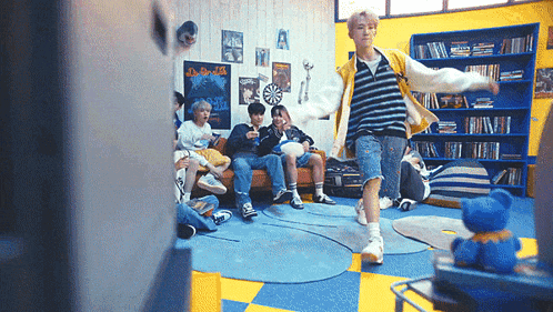 a group of young people are sitting on a couch in a room .