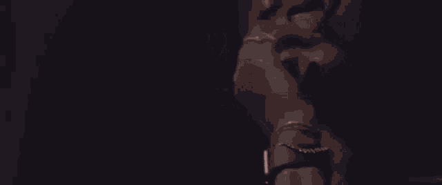 a man in a black shirt is making a middle finger gesture .