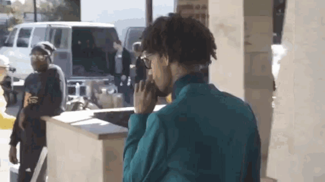 a man in a blue jacket is talking on a cellphone