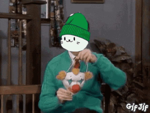a man wearing a green beanie and a green sweater is eating chicken nuggets ..