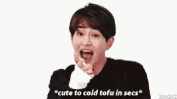 a man in a black shirt is eating tofu and says cute to cold tofu in secs .