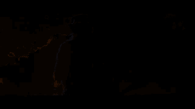 a blurry image of a person holding a lantern with a light coming out of it
