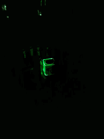 a green light is shining on a stack of cans with one that says ' a ' on it