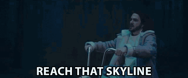 a man is riding a bicycle with the words `` reach that skyline '' written on the screen .
