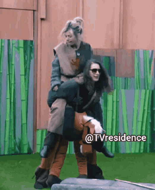 a woman is being carried on the back of another woman in a tv residence scene