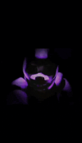 a blurry picture of a person 's face with a purple and red background