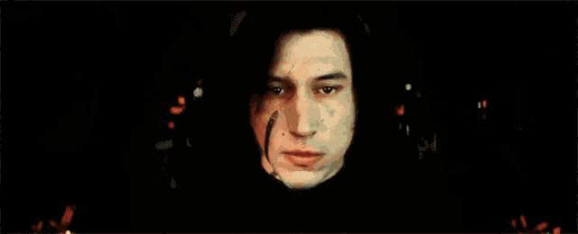 a close up of a man 's face in the dark .