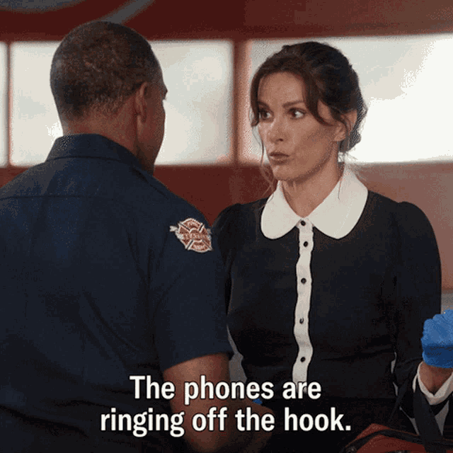 a woman talking to a fireman with the words " the phones are ringing off the hook "