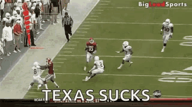 a group of football players on a field with the words texas sucks on the screen