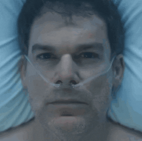 a man in a hospital bed with an oxygen mask on his nose
