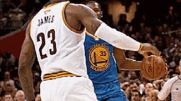 a basketball player with the number 23 on his jersey is dribbling the ball