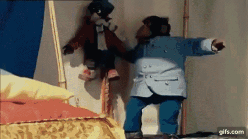 a monkey is holding a stuffed animal in a room .