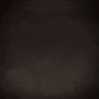 a close up of a person 's feathers with a dark background