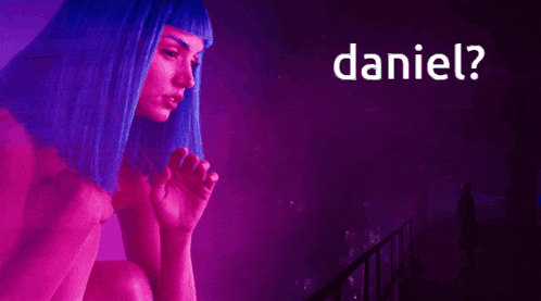 a woman with blue hair is pointing to the word daniel in the corner