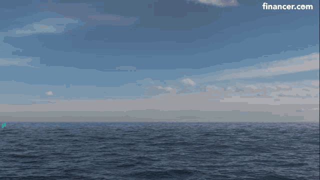 a blue coin with the letter e on it exploding in the ocean