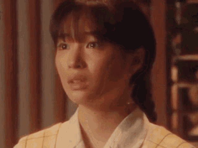 a close up of a woman 's face making a surprised face .