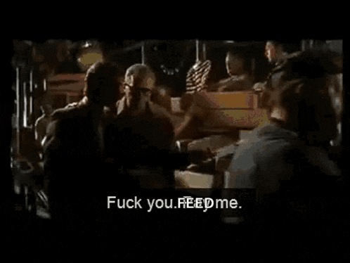 a man is talking to another man in a dark room and says `` fuck you , feed me '' .